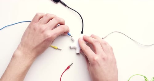 Techology, adapter and man hands with headphone port for audio jack or music connection on white