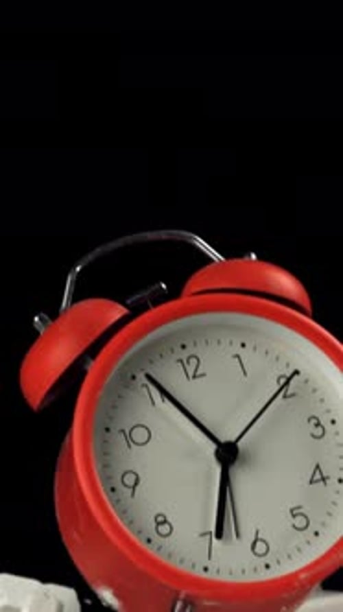 Alarm Clock and School Crayons Fly Up on a Black Background Filmed on a Highspeed Camera at 1000 Fps