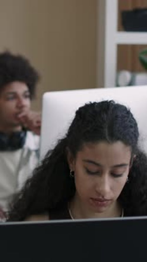 Vertical of Female Programmer Working on Computer in Office