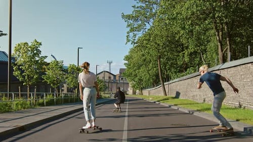 Cool Young Girl and Two Guys Riding Longboards and Skateboards Through Stylish Hip Cultural Part of