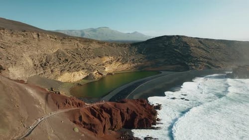 Vue aérienne par drone du Lago Verde, Green Lagoon, à Lanzarote, Espagne, avec des falaises volcaniques, noir