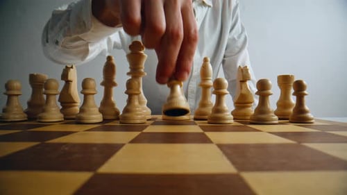 Player Hand Moving Figure in Strategy Game Closeup Chess Logic Tactic Board Game