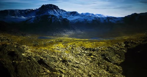 Mountainous Landscape with Rocky Terrain and Snow Capped Peaks During Daylight