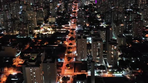 Night aerial view of downtown district with scenic and colorful buildings and illumination traffic a