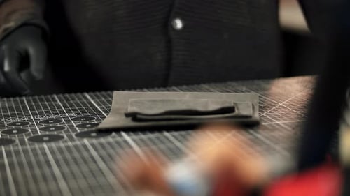 Craftsperson Working with Leather for Wallet on Worktable