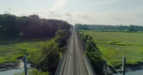 Aerial Forward Dolly Shot Closely Passing Over Speeding Train at Dawn