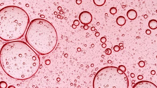 Bubble Cluster Cells Under a Microscope Transparent Cosmetic Gel Fluid with Molecule Bubbles Oil
