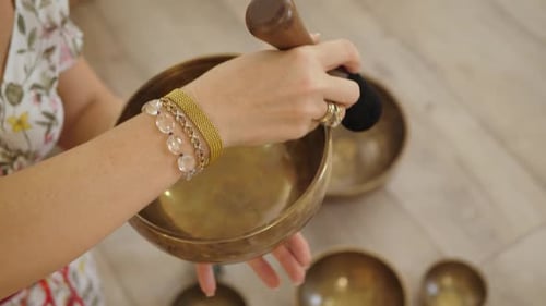 Woman Plays Singing Bowl for Meditation and Healing