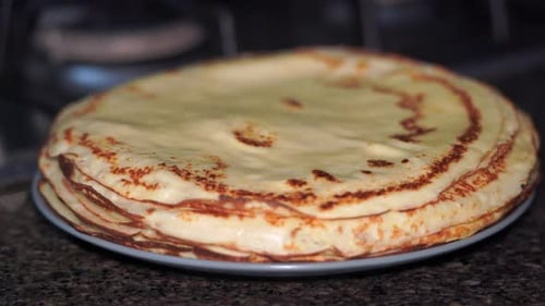 Golden Stack of Delicious Crepes on Plate