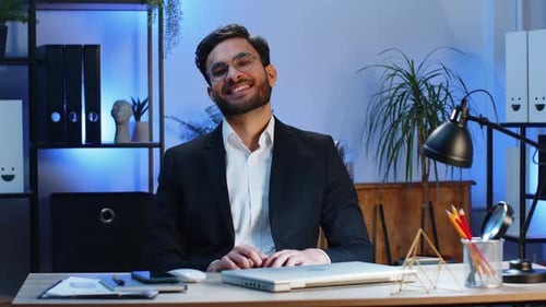 Indian Businessman Freelancer at Office Workplace Working on Laptop Computer Sends Online Messages