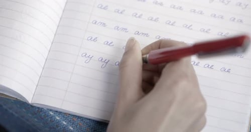 Close up – Writing on a workbook – Calligraphy practice