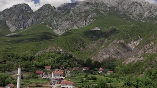 Aerial view of a small mountain village with a mosque