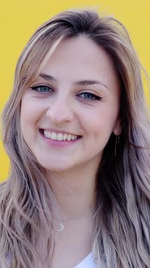 Smiling Woman Portrait Against Yellow Background