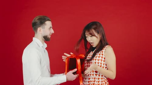 Woman Receives Gift and Hug From Young Man