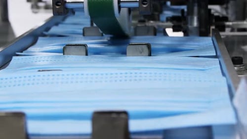 Machine Connects Elastic Bands to Surgical Masks on Conveyor