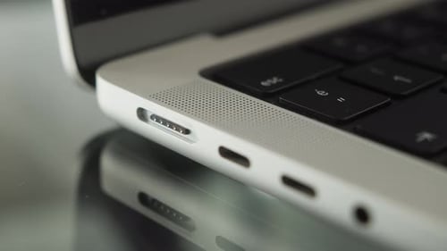 Charging Cable Connected to Silver Laptop Computer