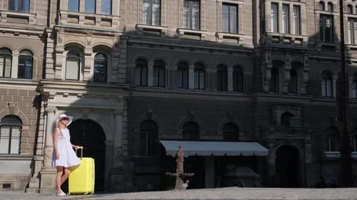 A Tourist Girl in a White Dress and Hat Came to Prague Summer Vacation in the Czech Republic