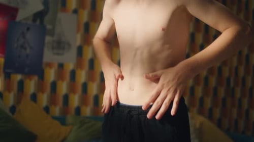 Shirtless Teen Boy Examines Himself