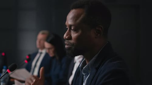 Speech Of Political Speaker At Meeting Room Of Modern Business Center. Adult Black Man In Suit Ex...