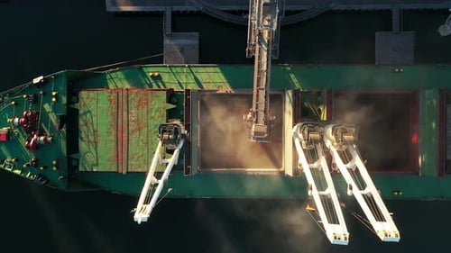 Aerial View Fom Above Wheat Loading to Bulker Ship Cargo Hold at Sea Grain Elevator in Sea Port