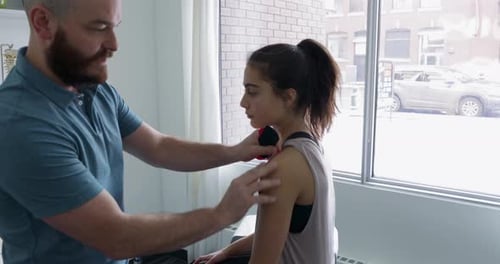 Kinesiology Tape Applied to Young Woman's Shoulder