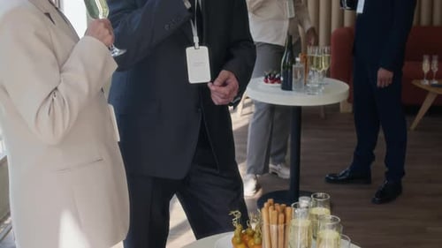Senior Man and Woman Sipping Sparkling Wine During Small Afterparty