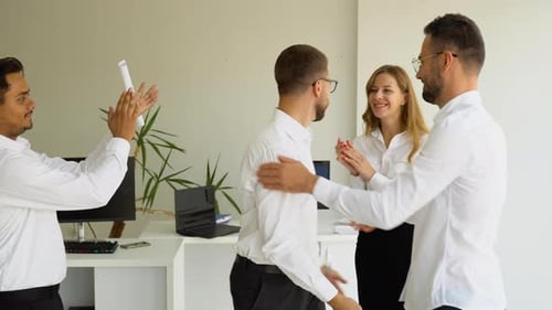 Happy Colleagues Celebrating Success in Office