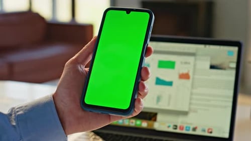 Smartphone with Green Screen held in Office