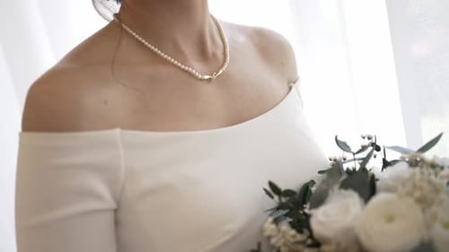 Bride Holding Bouquet of Roses on Wedding Day