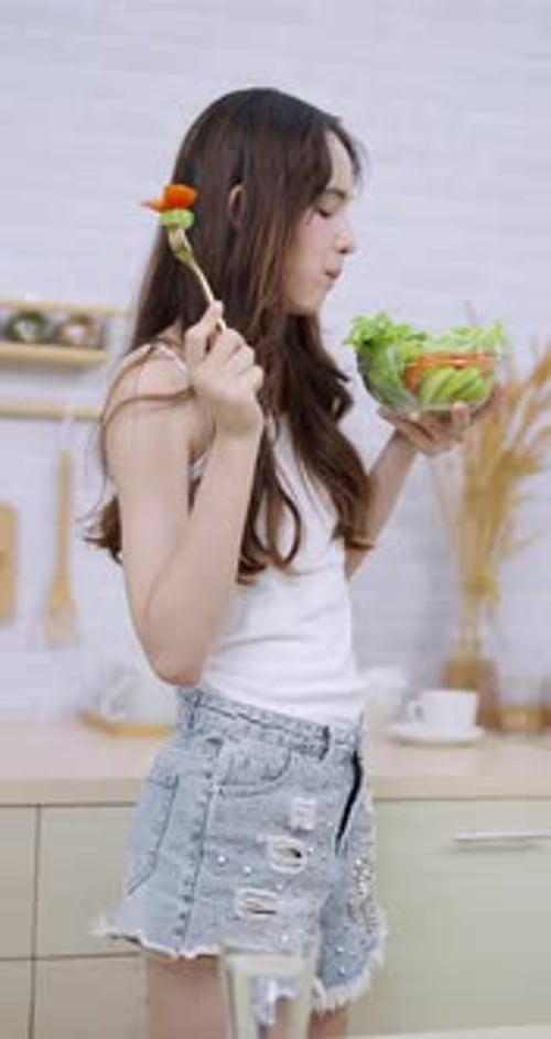 Woman Enjoys a Healthy Salad in Her Kitchen