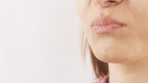 Close-up of woman eating chips.