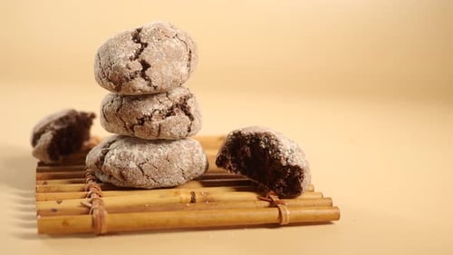 Powdered Chocolate Cookies Stacked on Bamboo Mat