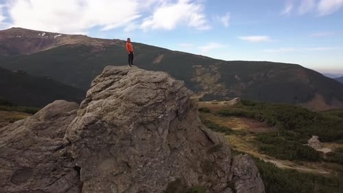 Aerial View of a Hiker Man Climbing Big Rock in Mountains