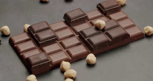 Delicious Chocolate Bar With Hazelnuts On A Dark Background