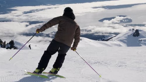 Man Skiing Down Mountain Ski Slope