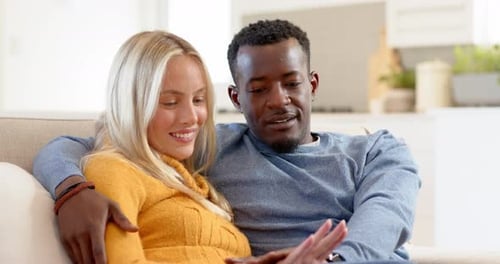 Happy Couple Holding Hands on Sofa at Home