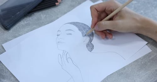 Hand Drawing Portrait with Pencil on White Paper