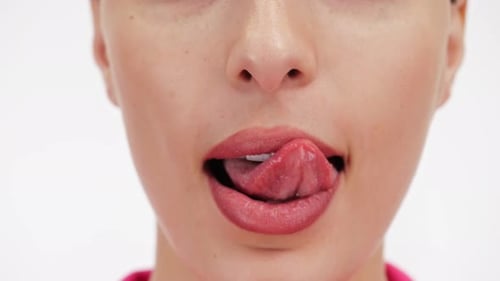 Woman's Mouth Licking Lips Close Up on White