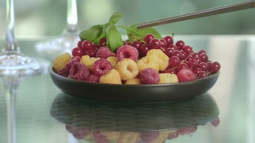 Bowl of Raspberries and Red Currants with Basil