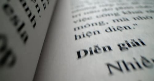 Macro View Open Book with White Pages Against Black Background