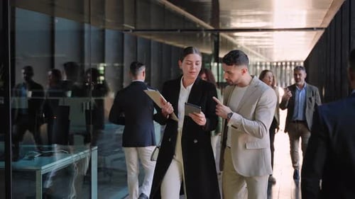 Two Young Business Startup Partners Walking in a Modern Office Building Going to Work While