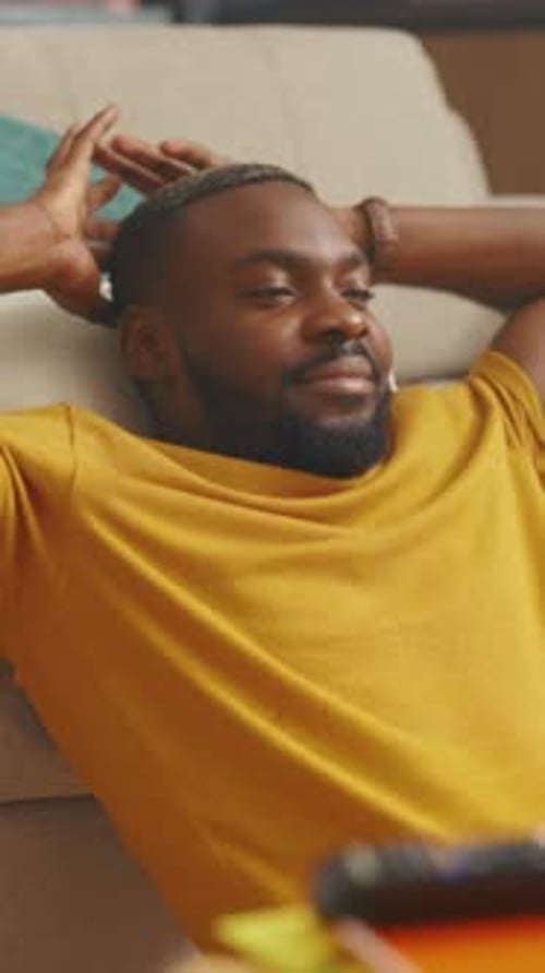 Casual Scene of Man Relaxing at Home Man in Comfortable Setting Spends Quiet Moments Reclining with
