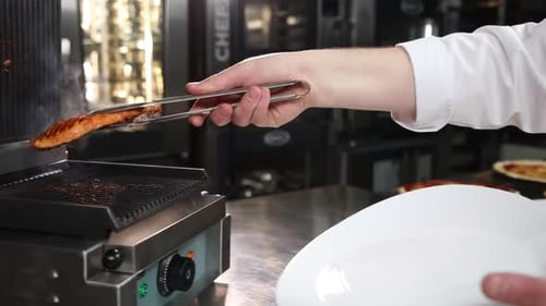 the chef prepares delicious meat in the restaurant