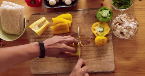 Chopping Fresh Yellow Bell Peppers for a Meal