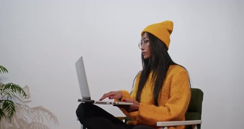 Woman Working on Laptop at Home
