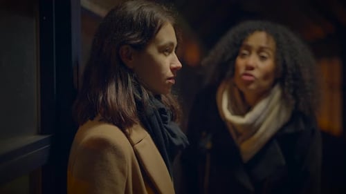 Two Women Talking Outside at Night