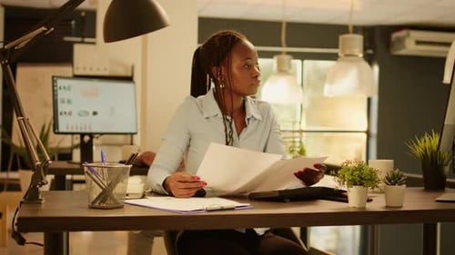 Woman Reviews Documents in Modern Office