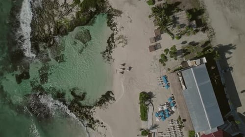 Descending aerial view pointing onto beach resort area, location Caleta Tankah, beautiful inlet or c