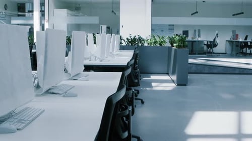 Empty Rental Office with Computers Wrapped in Cover