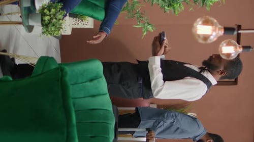 Stylish Meeting: Woman Presents Tablet to Man Indoors